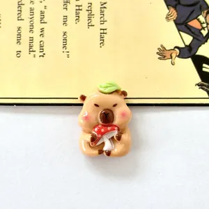 Macro view of a cute resin capybara accessory holding a red mushroom for DIY shoe charms