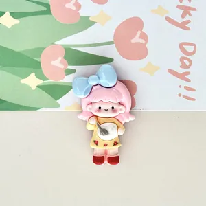 Macro detail of a cute pink-haired cartoon girl fridge magnet with a blue bow decoration