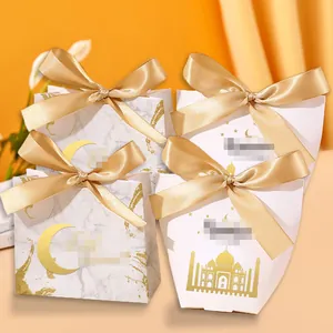 Detail of elegant gold-stamped candy boxes with satin ribbons and castle patterns