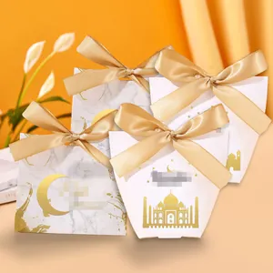 Elegant gold foil gift boxes with ribbons and mosque patterns for wedding favors