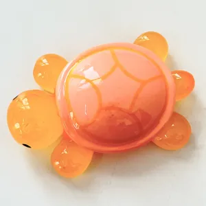 Macro view of a large luminous resin turtle figurine with orange translucent shell