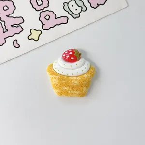 Close-up of a miniature resin strawberry cupcake charm for DIY handmade jewelry crafts