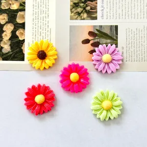 Close-up of colorful daisy resin flower charms for DIY crafts and accessories