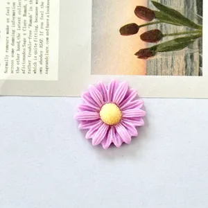 Detailed close-up of a small purple resin daisy flower accessory for DIY crafts.