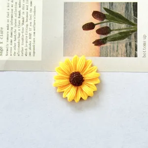 Detailed close-up of a vibrant yellow sunflower resin charm for DIY hair clips and crafts