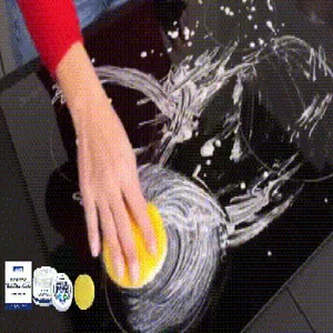 Close-up of multi-purpose cleaning paste removing grease stains from a glass stove