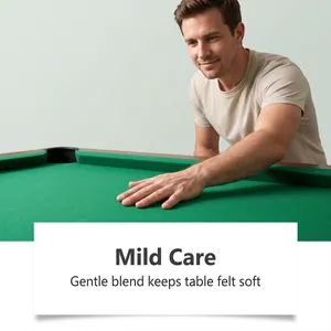 Close-up of a person's hand touching clean green billiard table felt to show softness