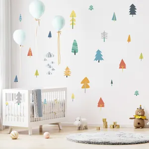 Hand-painted colorful woodland forest tree wall decals applied in a nursery room