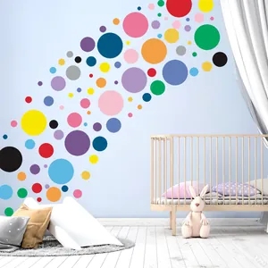 Colorful polka dot wall decals for nursery decor, showing various circles on light blue wall
