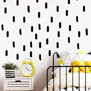 Autocollants muraux modernes à tirets noirs dans une chambre d'enfant au style épuré.