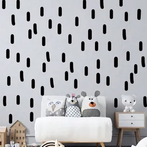 Autocollants muraux abstraits à rayures ovales noires sur un mur gris de chambre
