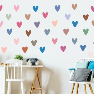 Detail view of colorful heart wall stickers decorating a cozy children's bedroom