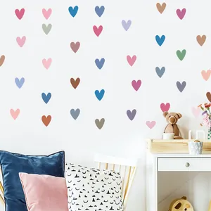 Detailed view of colorful heart wall stickers in a cozy children's bedroom setting