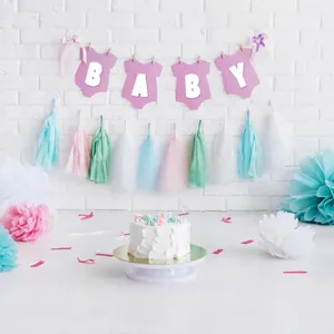 Decorative 2-inch white letter stickers forming BABY on pink banners for a baby shower scene