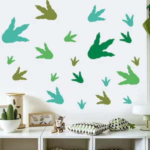 Green dinosaur footprint wall stickers applied in a cozy children's room setting