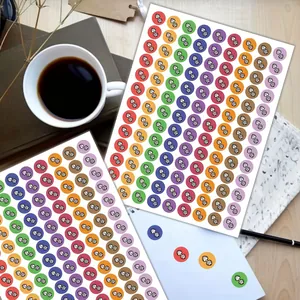 Detail showing multi-colored dumbbell icon stickers for fitness planning on a desk