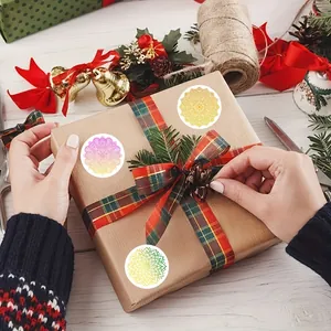 Decorative colorful mandala round stickers being applied to a brown paper gift box