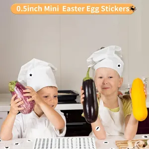 Two children in chef hats using 0.5 inch mini stickers on vegetables in a kitchen