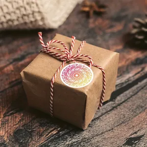 Close-up of a colorful mandala round sticker used as a gift box seal on brown paper