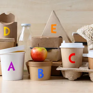 Colorful uppercase alphabet stickers applied on eco-friendly food packaging containers