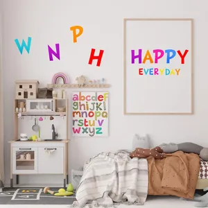 Colorful 1 and 2 inch alphabet stickers displayed as decor on a nursery room wall