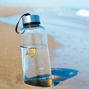 Detailed view of gold metallic DIY letter stickers L and y on a clear bottle