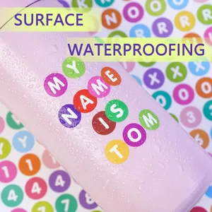 Macro detail of waterproof 0.5 inch alphabet stickers on a pink water bottle surface