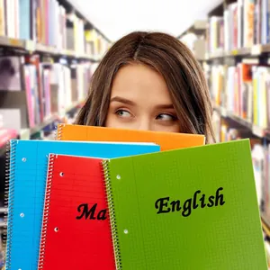 Black English alphabet decals applied to colorful spiral notebooks for personalization