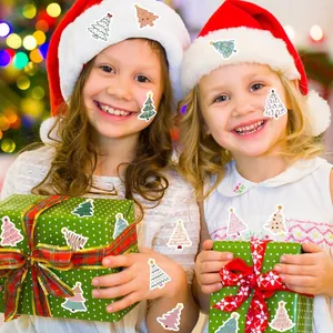 Children holding gifts decorated with various festive Christmas tree stickers