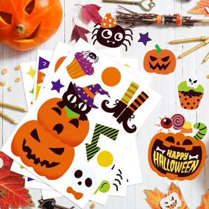 Detailed view of Halloween window stickers featuring cartoon pumpkins and cats on white wood