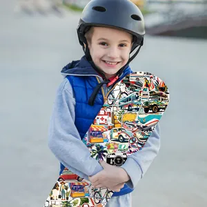 Macro view of colorful travel-themed waterproof stickers on a child's skateboard surface