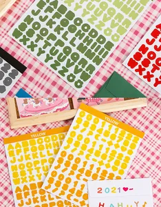 Close-up detail of vibrant palette alphabet and number sticker sheets for creative DIY journaling