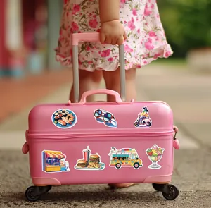 Detailed macro view of vibrant waterproof travel themed graffiti stickers on a pink suitcase