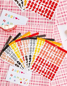 Detailed view of colorful alphabet and number stickers with application example on envelope