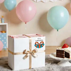 Close-up of a Feliz Cumpleaños sticker sealing a white gift box with a gold ribbon bow.