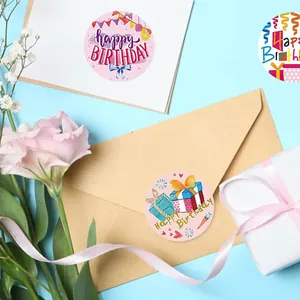 Macro view of colorful Happy Birthday stickers sealing a gift box and kraft envelope.