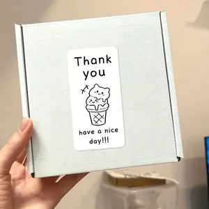Close-up of a white gift box with a cartoon cat ice cream thank you sticker label