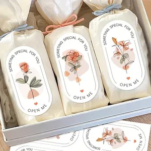 Macro view of elegant floral sealing stickers used on white gift packaging box