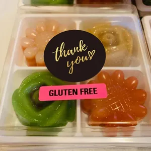 Premium round black hot stamping 'thank you' sticker used on gift box packaging detail