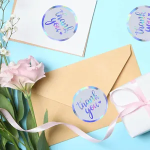 Decorative holographic circular thank you stickers applied to envelopes and gift boxes