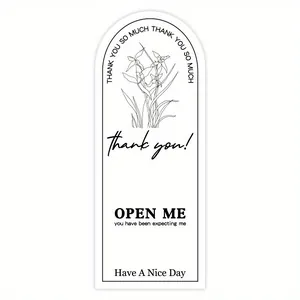 Detailed graphic of a white arched seal sticker with black floral art and thank you text