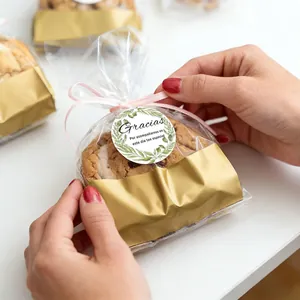 Close-up detail of round Gracias green leaf floral seal sticker on cookie gift packaging
