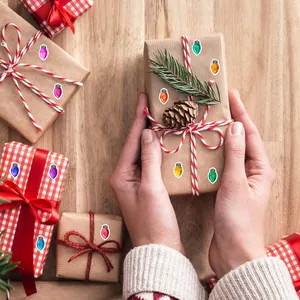 Detailed view of mini colorful Christmas light bulb stickers applied on festive gift boxes