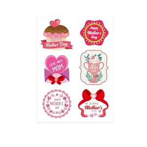 Macro view of pink Mother's Day gift stickers featuring floral and heart patterns