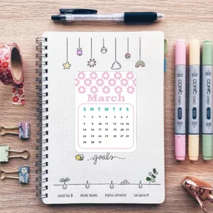 March calendar sticker with pink floral patterns placed on a spiral notebook page.
