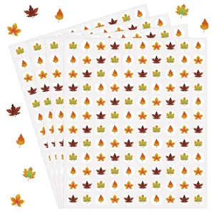 Macro detail of 1.3cm autumn leaf stickers on sheets for gift sealing and rewards.