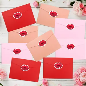 Close-up of red lip stickers used as envelope seals for Valentine's Day cards