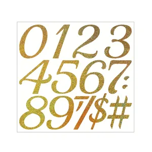 Macro detail of gold glitter number and symbol stickers for DIY gift card decorating.