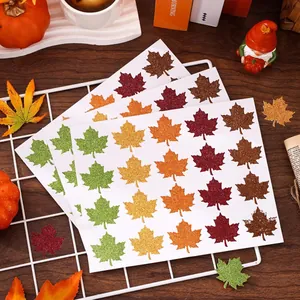 Macro view of five-color glitter maple leaf stickers for festive autumn theme crafts