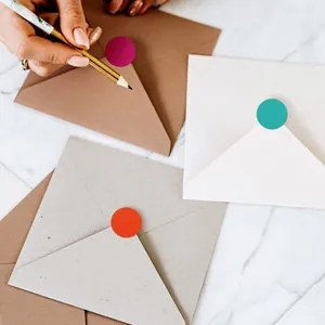 Close-up detail of 19mm colorful round dot stickers used for sealing paper envelopes